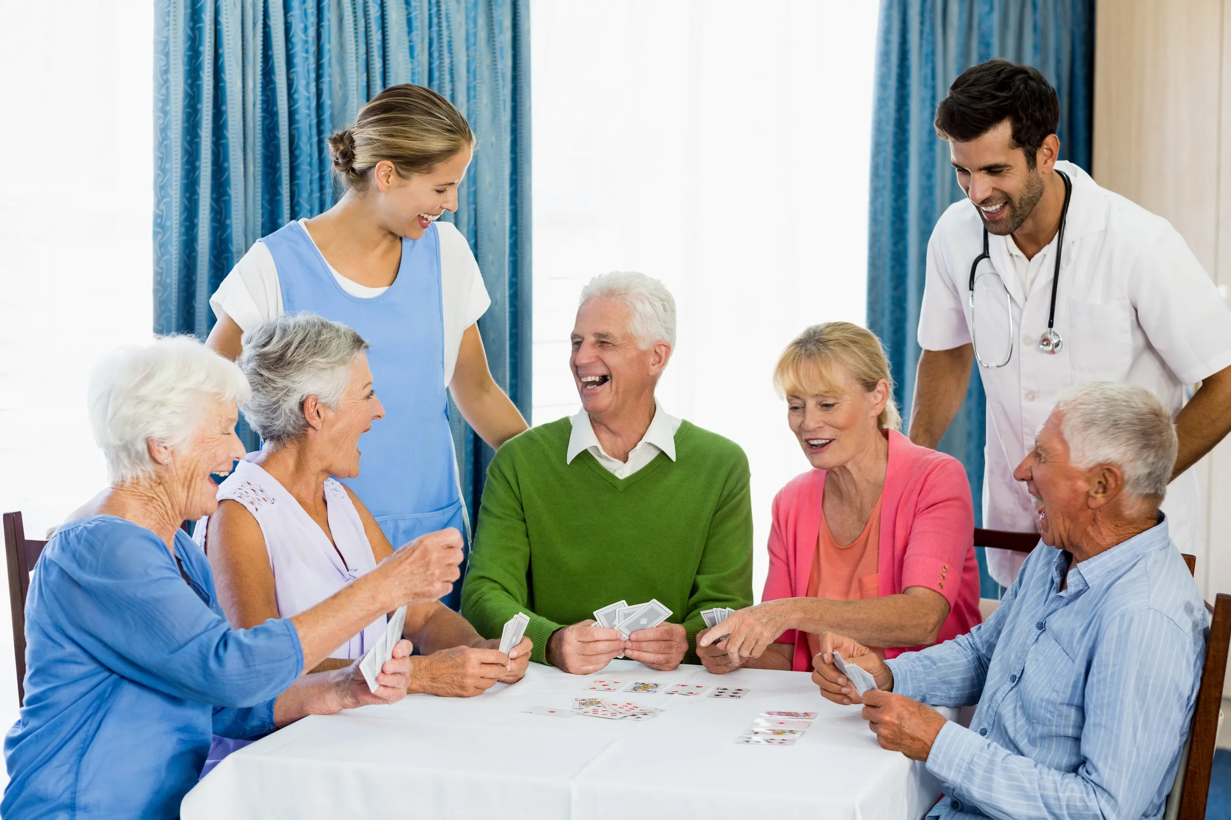 Seniors playing cards in a retirement home Seniors playing cards in a retirement home